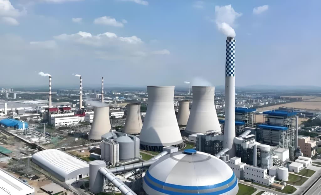 Thermal power plant with cooling towers and a tall chimney