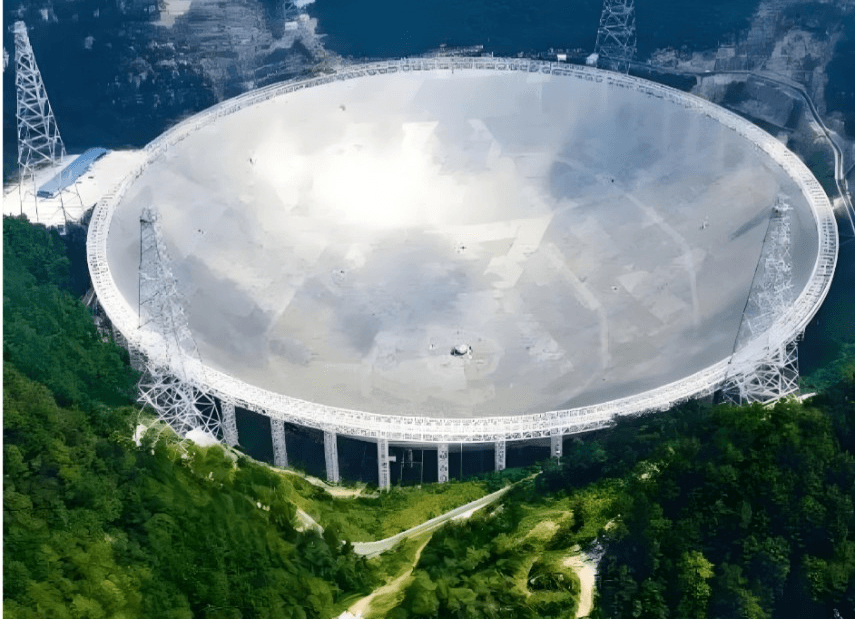 Aerial view of the FAST radio telescope dish set among karst mountains