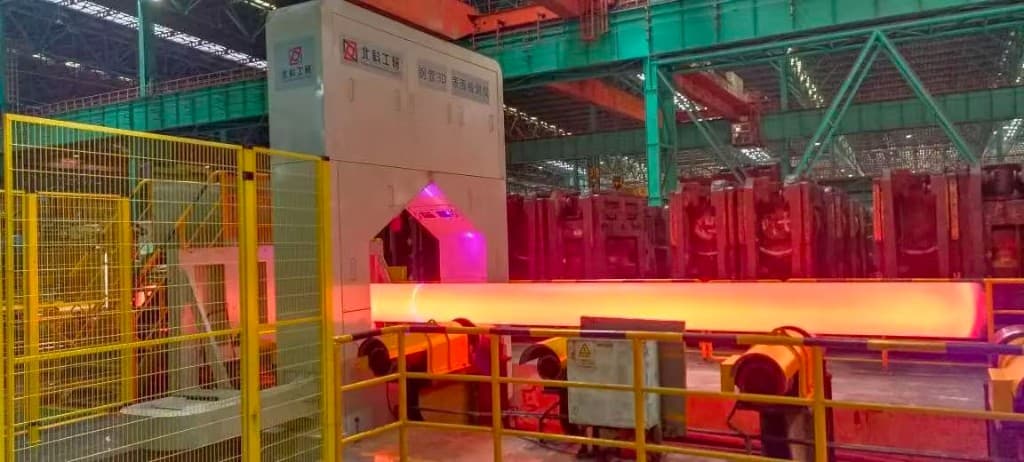 Red-hot seamless steel pipe passing through a 3D surface inspection station on the production line