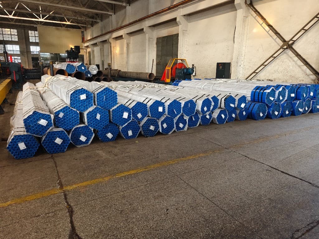 Rows of packaged pipe bundles staged in the warehouse before shipment